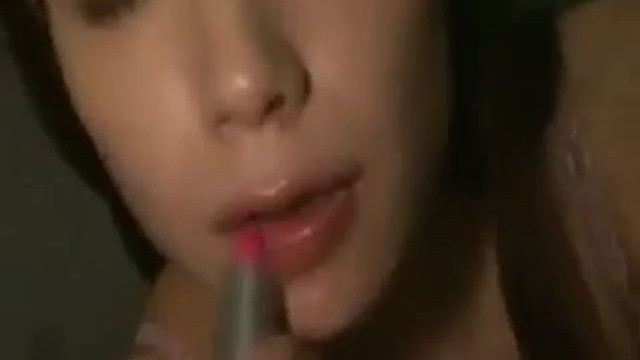 Closeup shot of an Asian wife going down and blowing her mouth